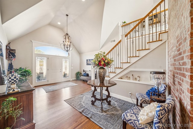 122 Osage Ridge Dr, Sand Springs, OK 74063 - foyer entrance featuring stairway, high vaulted ceiling, visible vents, and wood finished floors
