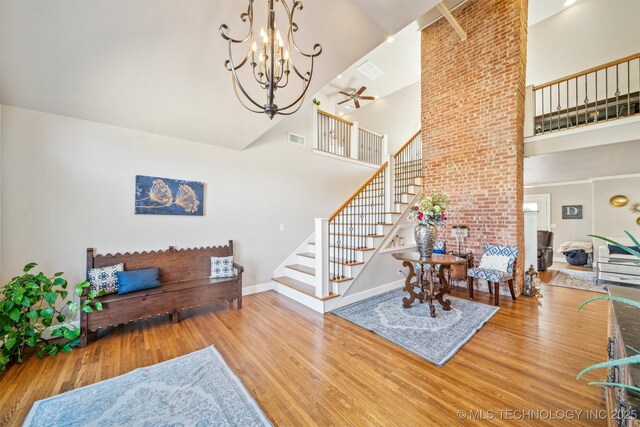 122 Osage Ridge Dr, Sand Springs, OK 74063 - living area featuring wood finished floors, visible vents, baseboards, stairs, and a towering ceiling