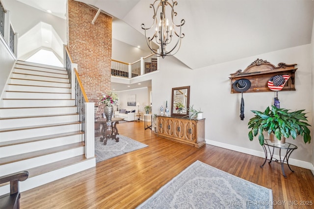 122 Osage Ridge Dr, Sand Springs, OK 74063 - interior space with a notable chandelier, stairway, high vaulted ceiling, and wood finished floors