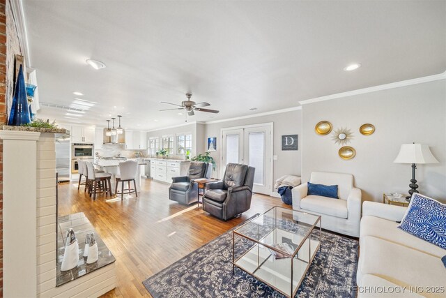 122 Osage Ridge Dr, Sand Springs, OK 74063 - living room featuring recessed lighting, light wood-style flooring, crown molding, and ceiling fan