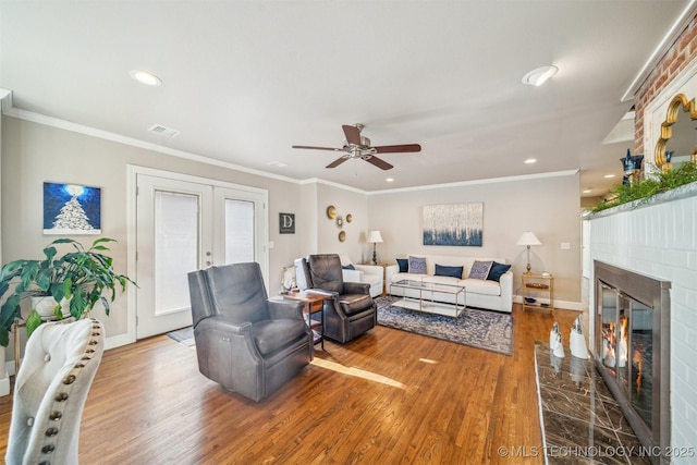 122 Osage Ridge Dr, Sand Springs, OK 74063 - living area featuring french doors, a ceiling fan, wood finished floors, and a fireplace