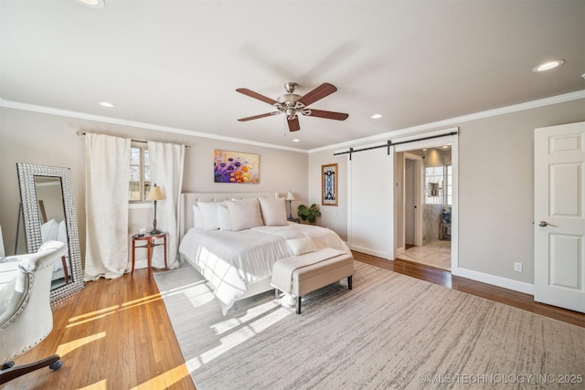 122 Osage Ridge Dr, Sand Springs, OK 74063 - bedroom featuring ornamental molding, baseboards, a barn door, and wood finished floors