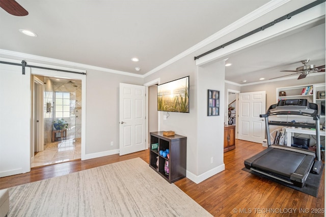 122 Osage Ridge Dr, Sand Springs, OK 74063 - exercise area featuring a barn door, ornamental molding, wood finished floors, and ceiling fan