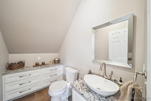 122 Osage Ridge Dr, Sand Springs, OK 74063 - bathroom featuring lofted ceiling, toilet, vanity, and tile patterned flooring