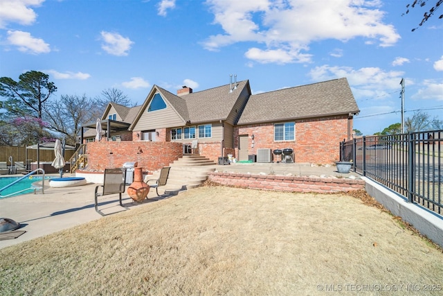 122 Osage Ridge Dr, Sand Springs, OK 74063 - rear view of house featuring a patio, a fenced backyard, and brick siding