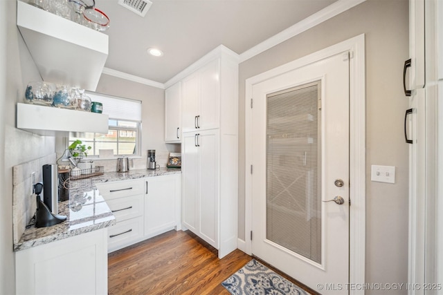 122 Osage Ridge Dr, Sand Springs, OK 74063 - kitchen with visible vents, ornamental molding, wood finished floors, white cabinets, and light stone countertops
