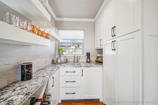 122 Osage Ridge Dr, Sand Springs, OK 74063 - kitchen with tasteful backsplash, white cabinets, ornamental molding, and light stone countertops