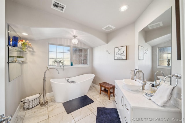 122 Osage Ridge Dr, Sand Springs, OK 74063 - bathroom with a freestanding tub, visible vents, lofted ceiling, and vanity