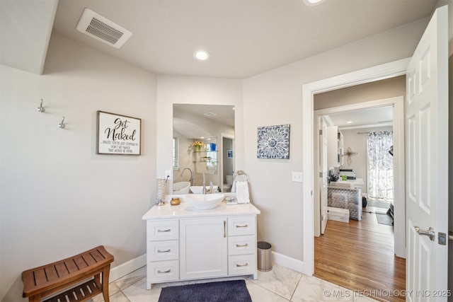 122 Osage Ridge Dr, Sand Springs, OK 74063 - bathroom featuring visible vents, baseboards, marble finish floor, and vanity