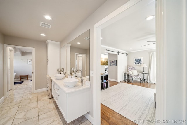 122 Osage Ridge Dr, Sand Springs, OK 74063 - bathroom featuring a sink, visible vents, double vanity, and recessed lighting