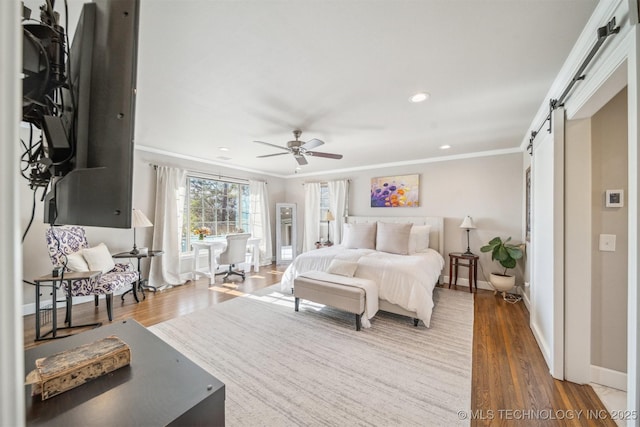 122 Osage Ridge Dr, Sand Springs, OK 74063 - bedroom with a barn door, wood finished floors, and crown molding