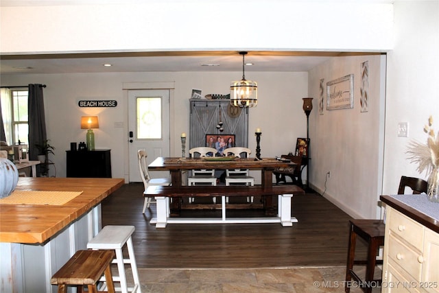 dining room with a chandelier and wood finished floors