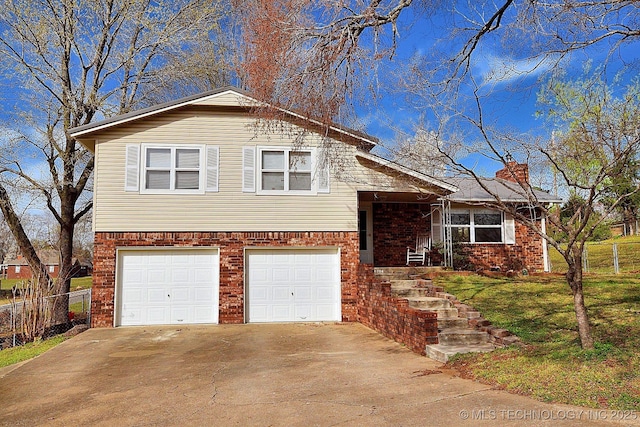 1004 S Owens Ave, Tahlequah, OK 74464 - tri-level home with an attached garage, a chimney, brick siding, and driveway