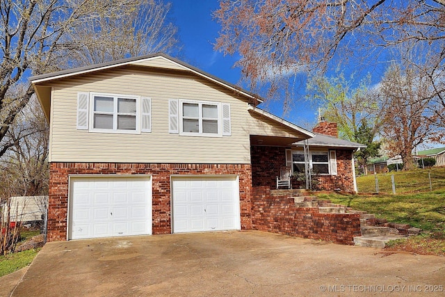 1004 S Owens Ave, Tahlequah, OK 74464 - split level home with a garage, a chimney, driveway, and brick siding
