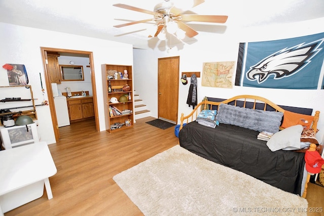 1004 S Owens Ave, Tahlequah, OK 74464 - bedroom featuring wood finished floors, a sink, washer / clothes dryer, and ceiling fan