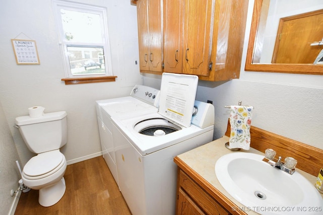 1004 S Owens Ave, Tahlequah, OK 74464 - laundry area with separate washer and dryer and wood finished floors