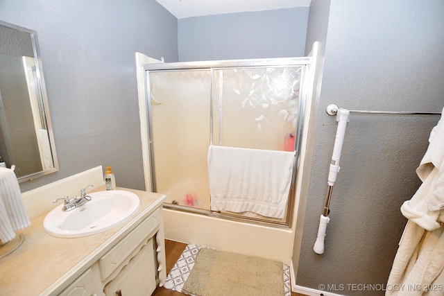 1004 S Owens Ave, Tahlequah, OK 74464 - full bathroom featuring vanity, combined bath / shower with glass door, and wood finished floors