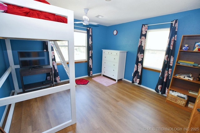 1004 S Owens Ave, Tahlequah, OK 74464 - bedroom featuring multiple windows, wood finished floors, and baseboards