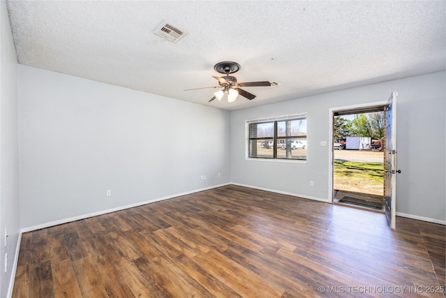 unfurnished room with ceiling fan, visible vents, a textured ceiling, and wood finished floors