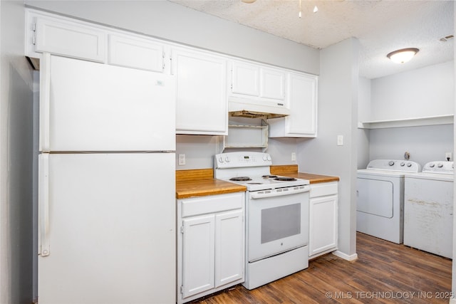 kitchen featuring under cabinet range hood, washing machine and dryer, white appliances, and white cabinets