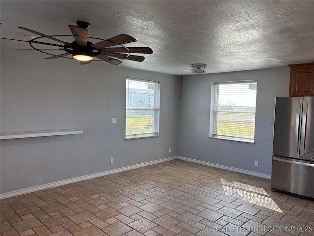34 S Mount Calvary Rd, Hendrix, OK 74741 - unfurnished room featuring a textured ceiling, ceiling fan, baseboards, and brick patterned floors