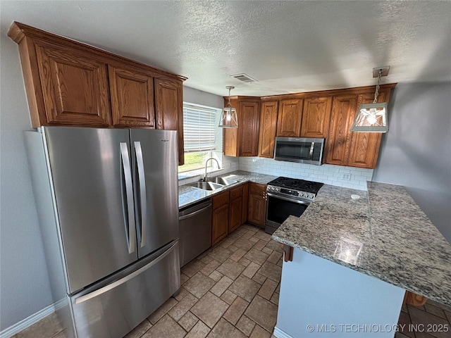 34 S Mount Calvary Rd, Hendrix, OK 74741 - kitchen featuring stainless steel appliances, a peninsula, a sink, brown cabinets, and decorative backsplash
