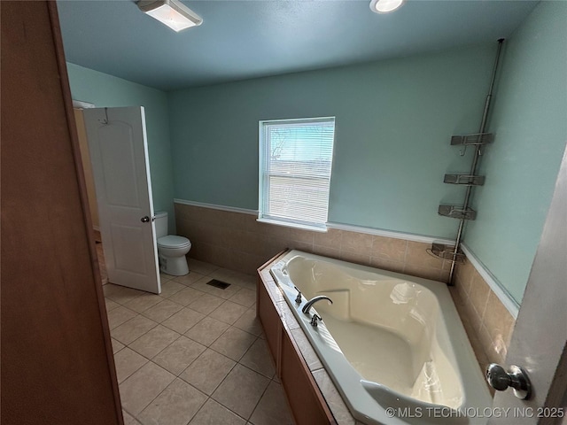 34 S Mount Calvary Rd, Hendrix, OK 74741 - bathroom with a bath, tile patterned flooring, wainscoting, toilet, and tile walls