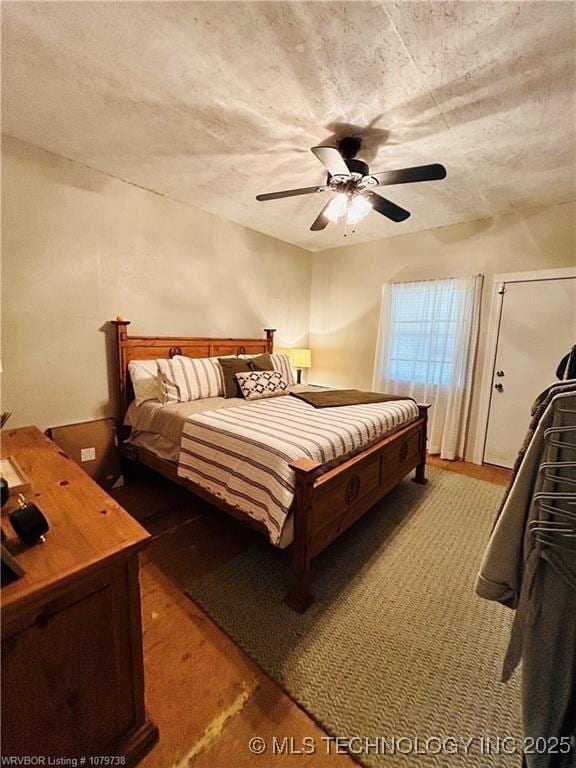 bedroom featuring a textured ceiling and ceiling fan