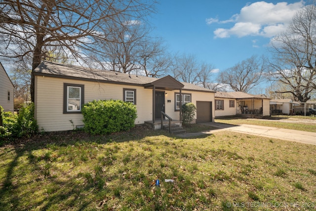 7380 E Independence St, Tulsa, OK 74115 - ranch-style home with a garage, concrete driveway, and a front yard