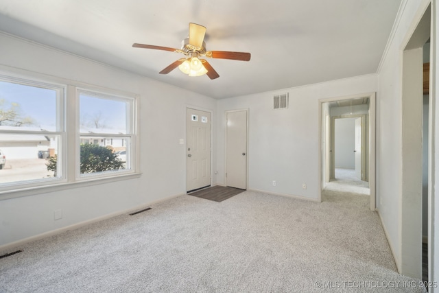 7380 E Independence St, Tulsa, OK 74115 - carpeted empty room with visible vents, attic access, crown molding, and a ceiling fan