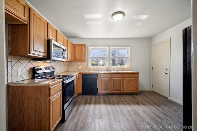 7380 E Independence St, Tulsa, OK 74115 - kitchen with stainless steel appliances, wood finished floors, decorative backsplash, and light countertops