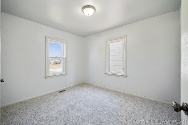 7380 E Independence St, Tulsa, OK 74115 - carpeted spare room with baseboards, visible vents, and ornamental molding