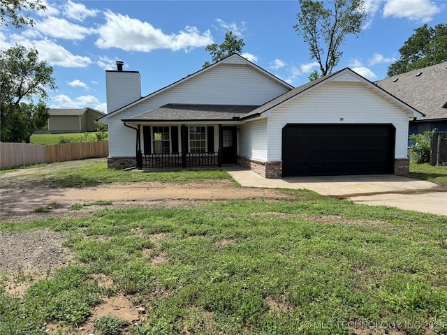 1103 S Chickasaw Pl, Claremore, OK 74017 - view of front of house featuring covered porch, driveway, brick siding, fence, and an attached garage