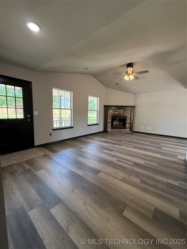 1103 S Chickasaw Pl, Claremore, OK 74017 - unfurnished living room with baseboards, ceiling fan, a healthy amount of sunlight, and lofted ceiling