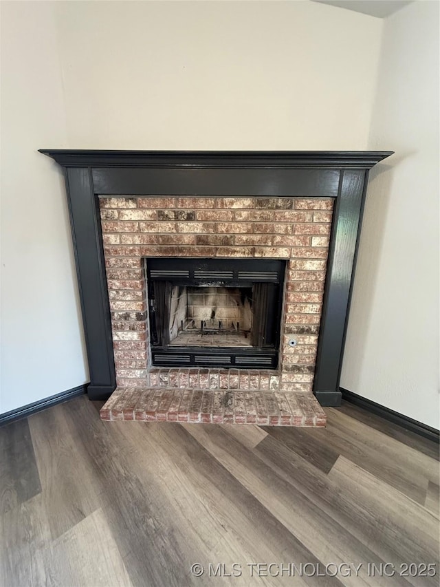 1103 S Chickasaw Pl, Claremore, OK 74017 - interior details with baseboards, a brick fireplace, and wood finished floors