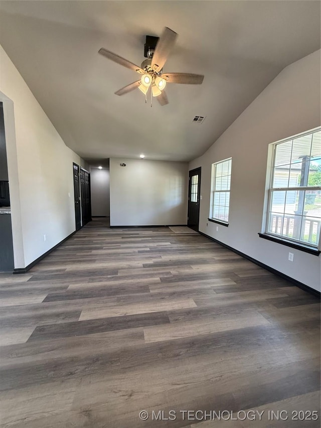 1103 S Chickasaw Pl, Claremore, OK 74017 - unfurnished living room with ceiling fan, lofted ceiling, wood finished floors, and visible vents