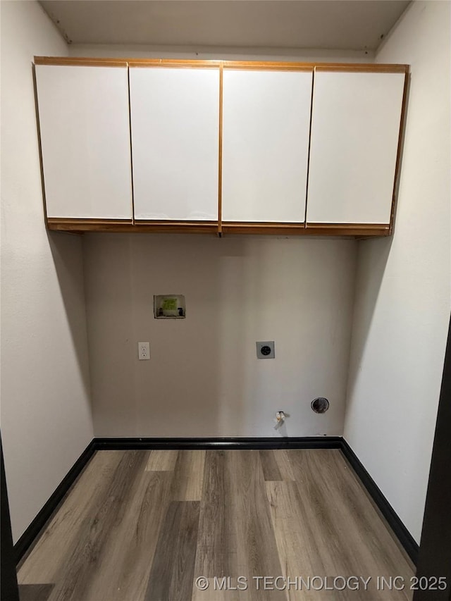1103 S Chickasaw Pl, Claremore, OK 74017 - clothes washing area featuring gas dryer hookup, hookup for an electric dryer, washer hookup, cabinet space, and wood finished floors