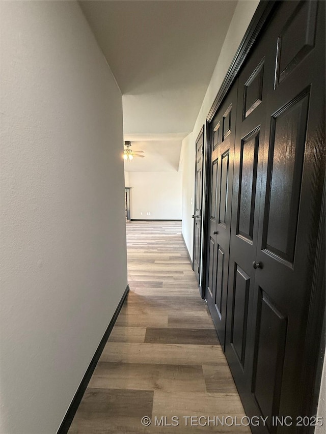 1103 S Chickasaw Pl, Claremore, OK 74017 - hallway featuring baseboards and wood finished floors