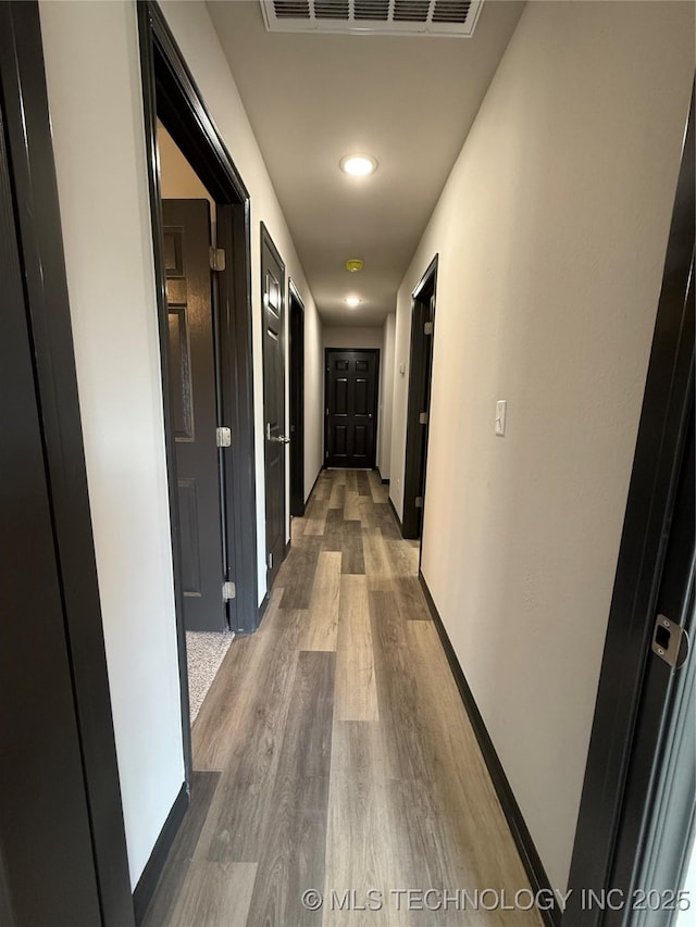 1103 S Chickasaw Pl, Claremore, OK 74017 - hall featuring recessed lighting, baseboards, visible vents, and wood finished floors