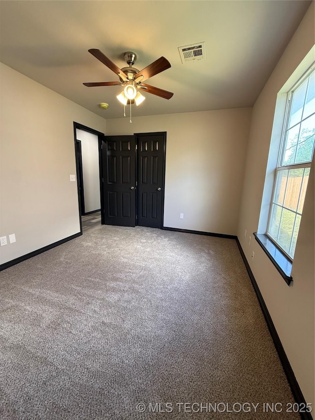 1103 S Chickasaw Pl, Claremore, OK 74017 - unfurnished bedroom featuring visible vents, baseboards, carpet floors, and ceiling fan