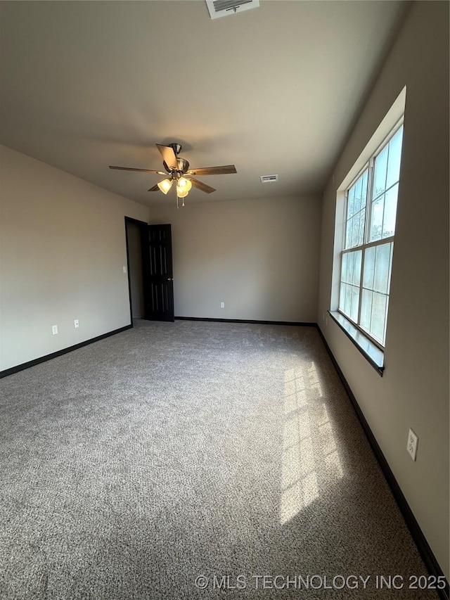 1103 S Chickasaw Pl, Claremore, OK 74017 - spare room featuring carpet flooring, ceiling fan, visible vents, and baseboards