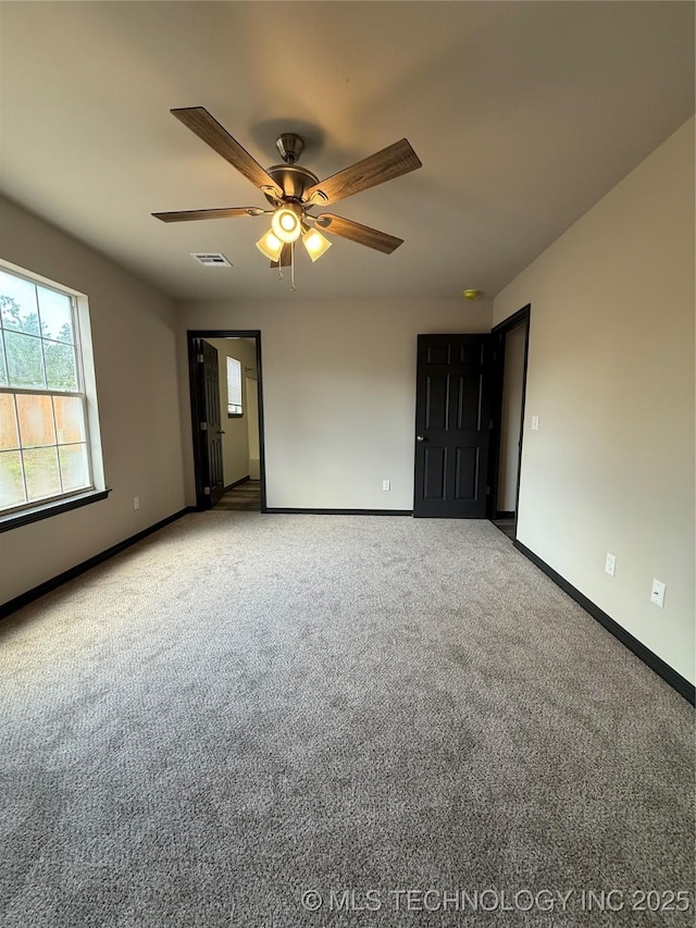 1103 S Chickasaw Pl, Claremore, OK 74017 - carpeted empty room featuring baseboards, ceiling fan, and visible vents
