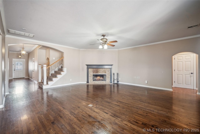 11727 S 91st E Ave, Bixby, OK 74008 - unfurnished living room with arched walkways, a ceiling fan, a lit fireplace, ornamental molding, and stairs