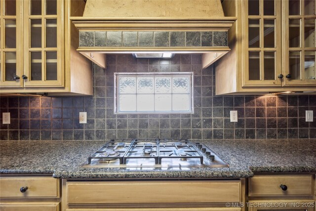 11727 S 91st E Ave, Bixby, OK 74008 - kitchen with stainless steel gas stovetop, decorative backsplash, glass insert cabinets, and dark stone countertops