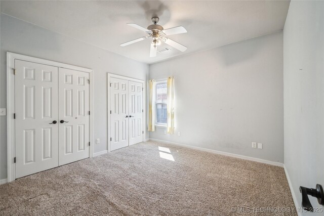 11727 S 91st E Ave, Bixby, OK 74008 - unfurnished bedroom featuring two closets, carpet flooring, baseboards, and ceiling fan