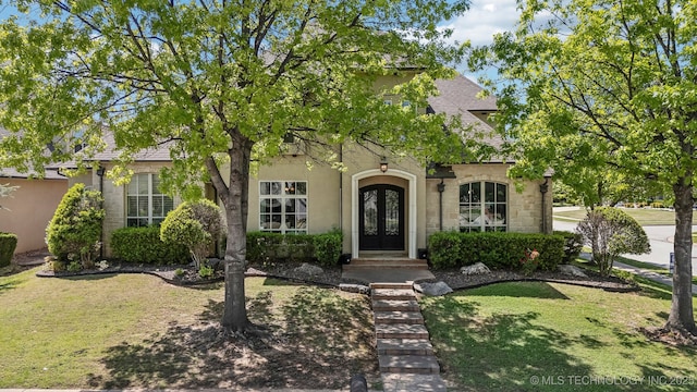 10848 S 95th E Ave, Tulsa, OK 74133 - view of front of home with french doors, a front lawn, and stucco siding