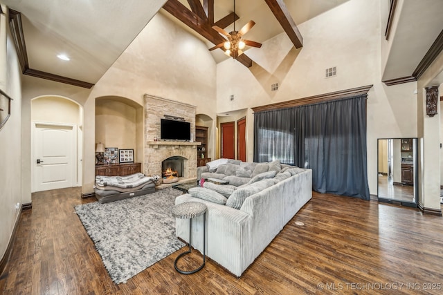 10848 S 95th E Ave, Tulsa, OK 74133 - living room with a ceiling fan, a fireplace, a high ceiling, dark wood-type flooring, and visible vents
