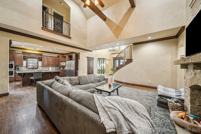 10848 S 95th E Ave, Tulsa, OK 74133 - living area with high vaulted ceiling, stairway, ceiling fan, a fireplace, and dark wood-type flooring
