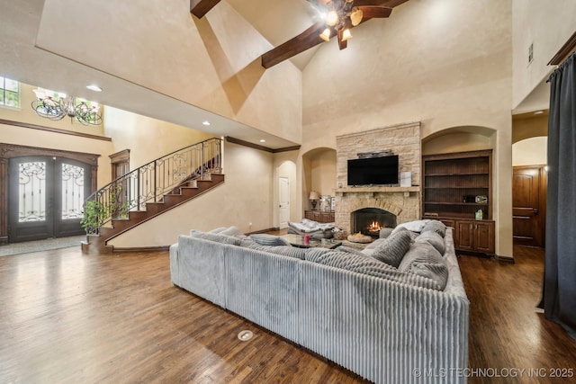 10848 S 95th E Ave, Tulsa, OK 74133 - living room with a towering ceiling, wood finished floors, french doors, arched walkways, and stairs
