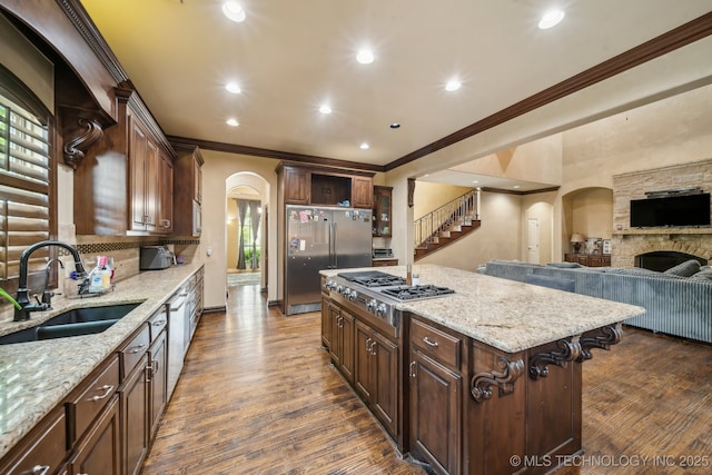 10848 S 95th E Ave, Tulsa, OK 74133 - kitchen with crown molding, a sink, arched walkways, appliances with stainless steel finishes, and light stone countertops